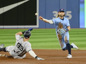 Blue Jays shortstop Bo Bichette throws to first base after New York Yankees' Aaron Judge is forced out at second base during fourth inning in Toronto on Wednesday, May 4, 2022.