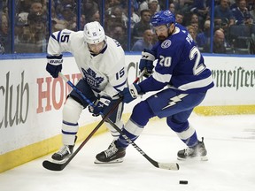 Alexander Kerfoot, here battling for the puck against Lightning’s Nick Paul, is believed, at some point, to have played in 11 of 12 possible forward slots for the Leafs this season.