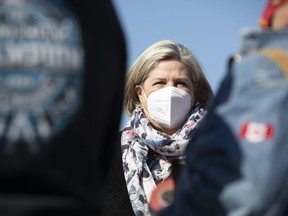 Ontario NDP Leader Andrea Horwath talks to construction workers as she makes an announcement in Bowmanville, Ont., Saturday, May 7, 2022.