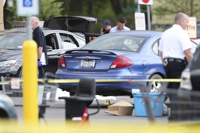 Police respond to the scene of a shooting in the parking lot of a supermarket where several people were killed in a shooting, Saturday, May 14, 2022 in Buffalo, N.Y.