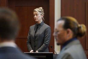 Amber Heard and Johnny Depp watch as the jury comes into the courtroom after a break at the Fairfax County Circuit Courthouse in Fairfax, Va., Monday, May 16, 2022.