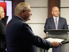 Ontario NDP Leader Andrea Horwath, left to right, Ontario PC Party Leader Doug Ford and Ontario Liberal Leader Steven Del Duca look on during the Ontario party leaders' debate, in Toronto, Monday, May 16, 2022.