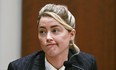 Amber Heard testifies in the courtroom at the Fairfax County Circuit Courthouse in Fairfax, Va., Tuesday, May 17, 2022.  to herself as a "public figure representing domestic abuse."