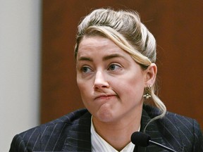 Amber Heard testifies in the courtroom at the Fairfax County Circuit Courthouse in Fairfax, Va., Tuesday, May 17, 2022.  to herself as a "public figure representing domestic abuse."