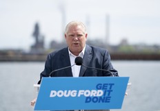 Premier Doug Ford makes an announcement on the with Stelco as a backdrop during an election campaign stop in Hamilton on Wednesday, May 18, 2022.