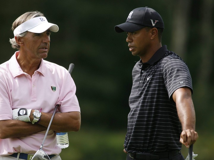  In this Sept. 3, 2009, file photo, Tiger Woods, right, talks with Seth Waugh during the pro-am round of the Deutsche Bank Championship in Norton, Mass. (AP Photo/Stew Milne)