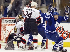 Toronto Maple Leafs' Chad Kilger (right) celebrates teammate Bryan McCabe's third-period goal past Ottawa Senators goaltender Martin Prusek (left) as Sens' Anton Volchenkov looks on during Game 7 of their Eastern Conference quarter-final in Toronto, Tuesday, April 20, 2004. Leafs won 4-1 to eliminate the Senators and move on to face the Philadelphia Flyers.