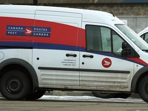Canada Post vehicles parked at a postal delivery depot in southeast Edmonton on Thursday November 22, 2018.