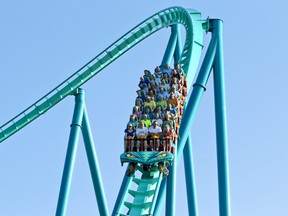 People ride a roller-coaster at Canada's Wonderland