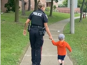 A Peel Regional Police officer looks after a child who wandered away from home