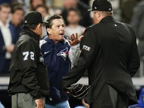 Blue Jays manager Charlie Montoyo argues with umpires Alfonso Marquez (72) and Lance Barrett after Blue Jays relief pitcher Yimi Garcia was ejected from the game during the sixth inning against the Yankees in New York City, Tuesday, May 10, 2022.