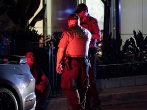 Chicago Police stand at a shooting scene after gunfire erupted on Thursday night outside a McDonald's near the city's Magnificent Mile shopping section, early Friday, May 20, 2022 in this picture obtained from social media.