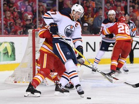 Oilers forward Connor McDavid (97) battles for the puck during Edmonton's playoff series against the Calgary Flames.