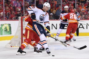 Oilers forward Connor McDavid (97) battles for the puck during Edmonton's playoff series against the Calgary Flames.