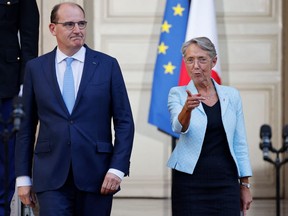 France's outgoing Prime Minister Jean Castex (left) and his successor, former Labour Minister Elisabeth Borne (right), arrive for speeches during a handover ceremony in the courtyard of the Hotel Matignon, French Prime ministers' official residence, in Paris on May 16, 2022.