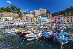 Small fishing boats at harbour Marina Grande in Sorrento on the Amalfi Coast in Italy. GETTY IMAGES