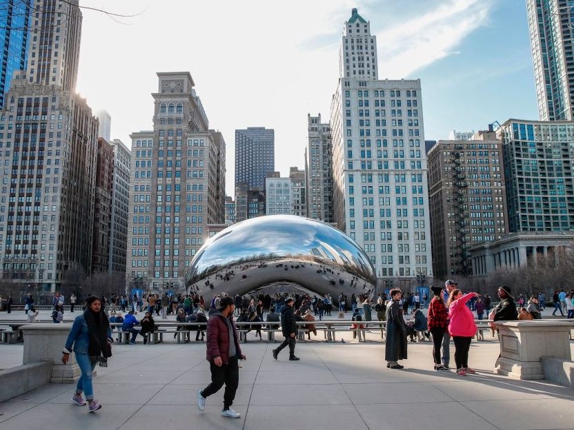 People visit Cloud Gate statue, known as the "Bean", in Millennium Park in Chicago, Illinois, on March 13, 2020. (Photo by KAMIL KRZACZYNSKI/AFP via Getty Images)