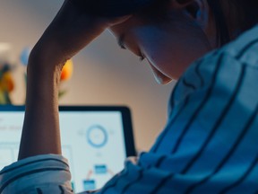 Young, exhausted employee working from home