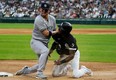 Josh Donaldson of the New York Yankees blocks third base as Tim Anderson of the Chicago White Sox tries to get back to the base at Guaranteed Rate Field on May 13, 2022 in Chicago, Illinois.