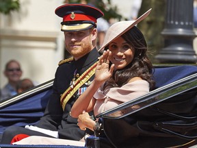 Britain's Prince Harry, Duke of Sussex and Britain's Meghan, Duchess of Sussex return in a horse-drawn carriage after attending the Queen's Birthday Parade, 'Trooping the Colour' on Horseguards parade in London on June 9, 2018. (Photo by NIKLAS HALLE'N/AFP via Getty Images)