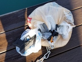 This bag of guns was affixed to a drone that police believe was flown from the U.S. into Canada near Sarnia, where it became stuck in a tree. PHOTO: OPP
