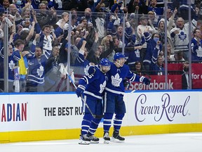 Toronto Maple Leafs forward Michael Bunting (58) celebrates his goal against the Tampa Bay Lightning with Toronto Maple Leafs defenseman Mark Giordano (55) in the second period of the second game of the first round of the 2022 Stanley Cup Playoffs at Scotiabank Arena.