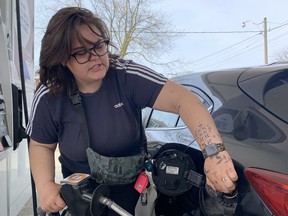 Dogwalker Rhianna Myatt fills her tank on Thursday, May 5, 2022, hours before an expected rise in prices on Friday.