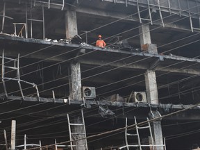 National Disaster Response Force (NDRF) and fire brigade personnel conduct a search and rescue operation after a fire broke out in a commercial building, in New Delhi, India, May 14, 2022.