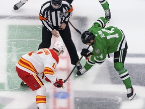 Calgary Flames center Mikael Backlund, left, and Dallas Stars left wing Jamie Benn take the opening face-off during the first period in game three of the first round of the 2022 Stanley Cup Playoffs at American Airlines Center in Dallas, May 7, 2022.