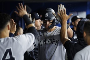 New York Yankees’ Aaron Judge celebrates a solo home run in the dugout during the sixth inning against the Blue Jays at Rogers Centre on Tuesday, May 3, 2022 in Toronto. COLE BURSTON/GETTY IMAGES