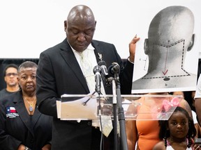 Attorney Ben Crump holds up a diagram explaining Jalen Ja'Von Randle's gunshot wound during a news conference on May 11, 2022 in Houston.