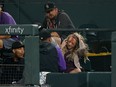 Reporter Kelsey Wingert reacts after being struck in the head by a foul ball at Coors Field.