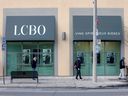 People wait outside the LCBO to buy alcohol in Toronto, April 9, 2020.  