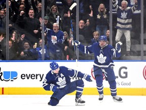 Maple Leafs' Mitch Marner (left) celebrates with Auston Matthews after scoring a goal against the Tampa Bay Lightning in Game 1 of the first round of the Stanley Cup playoffs at Scotiabank Arena on Monday, May 2, 2022.