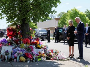U.S. President Joe Biden and first lady Jill Biden pay their respects to the 10 people killed in a mass shooting by a gunman authorities say was motivated by racism, at the TOPS Friendly Markets memorial site in Buffalo, May 17, 2022.