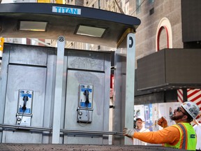 A worker loads the last public payphone on to a truck during the removal near Times Square in New York City on May 23, 2022.