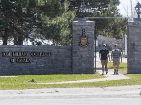 People walk off the campus of the Royal Military College in Kingston, Ontario, on Friday April 29, 2022.