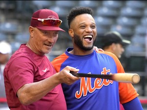 Arizona Diamondbacks bench coach Jeff Banister, left, talks to New York Mets second baseman Robinson Cano before a game at Chase Field in Phoeniz, Ariz., April 22, 2022.