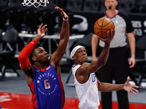 Clippers guard Rajon Rondo (4) shoots on Detroit Pistons guard Hamidou Diallo (6) at Little Caesars Arena.