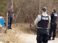 An asylum seeker crosses into Canada from the U.S. border near a checkpoint on Roxham Road near Hemmingford, Que., April 24, 2022.