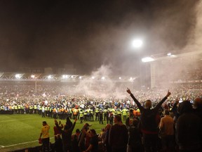 Soccer Football - Championship - Play-Offs Second Leg - Nottingham Forest v Sheffield United - The City Ground, Nottingham, Britain - May 17, 2022
Nottingham Forest fans celebrate on the pitch after reaching the Championship Play Off Final.