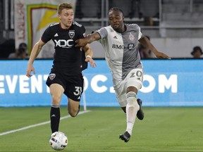 May 21, 2022; Washington, District of Columbia, USA; DC United defender Julian Gressel (31) dribbles the ball as Toronto FC striker Ayo Akinola (20) chases after Audi Field in the second half.