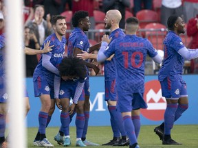Toronto FC forward Deandre Kerr (29) celebrates with midfielder Michael Bradley (4) after scoring a goal against the Chicago Fire during the first half at BMO Field.