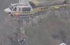 Television broadcasts showed a helicopter lifting someone to safety after an accident.