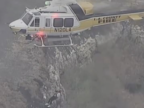 Television broadcasts showed a helicopter lifting someone to safety after an accident.