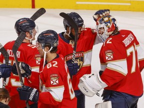 Panthers teammates congratulate goaltender Sergei Bobrovsky, right, after a 5-3 win against the Capitals in Game 5 of the first round of the 2022 NHL Stanley Cup Playoffs at the FLA Live Arena in Sunrise, Fla., Wednesday, May 11, 2022.