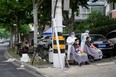 Residents get haircuts on a closed street during lockdown amid the COVID-19 pandemic, in Shanghai, China, Friday, May 20, 2022.