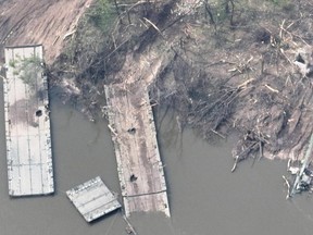 An aerial view of the remains of what appears to be a makeshift bridge across the Siverskyi Donets River, eastern Ukraine, in this handout image uploaded on May 12, 2022.