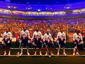 Members of the Toronto Rock lacrosse team join spectators at KeyBank Center in a moment of silence on May 15, 2022, to remember those who were killed in a mass shooting in Buffalo a day earlier.