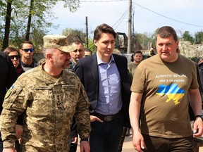 In this handout picture released on May 8, 2022 on the Telegram channel of Irpin Mayor Oleksandr Markushyn (right), Prime Minister Justin Trudeau (centre) visits the city of Irpin on May 8, 2022 amid the Russian invasion of Ukraine.
